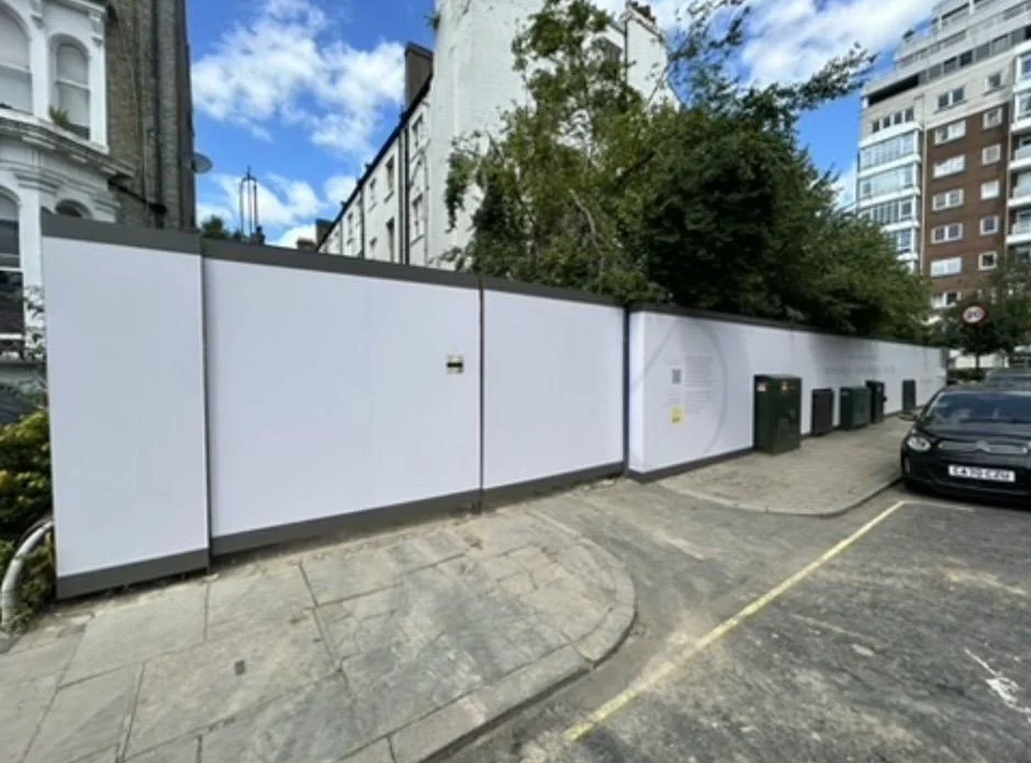 Bespoke hoarding, photo 1: Hoarding clad with cut and folded edges and a PED gate