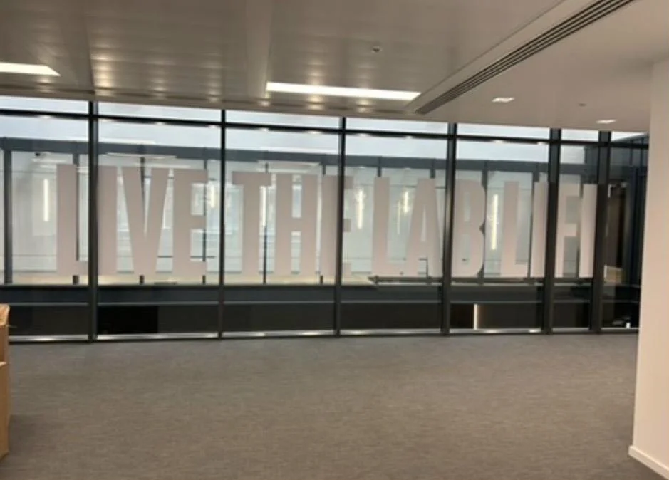Event vinyl and acrylic, photo 2: Acrylic panels on stand-offs with wall vinyl, large vinyl text on glass